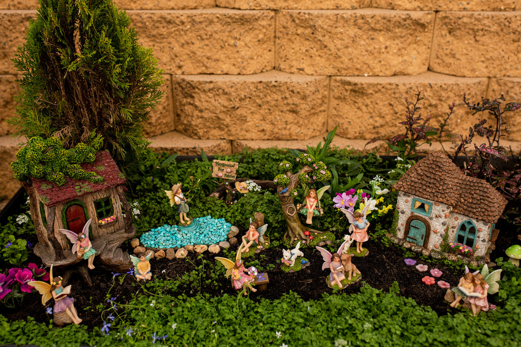 Pretmanns Fairy Garden setting with two fairy houses, a fairy swing set, fishing fairy and more